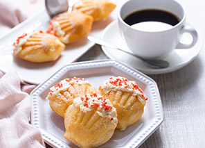 Coffee and assorted pastries served on a table, representing afternoon coffee, treats, and social gatherings like at Milaca Elim Meadows