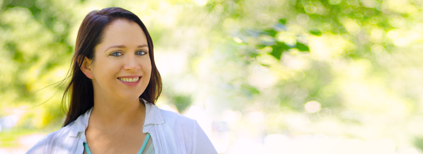 Portrait of an adult outdoors with a blurred natural background, representing welcoming support and contact services like at Milaca Elim Meadows