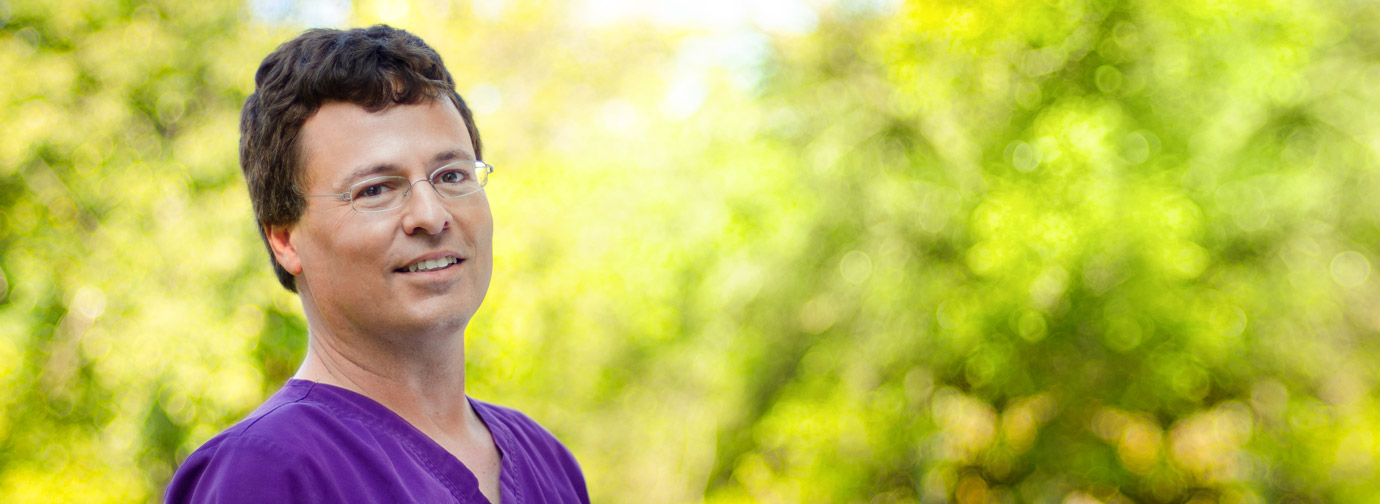 Employee portrait outdoors with a blurred green background, representing staff like at Milaca Elim Meadows