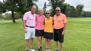 Four golfers pose together on the course during the 2026 Milaca Elim Meadows Golf Classic at Stones Throw Golf Course.